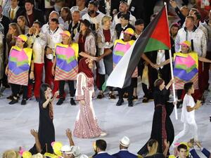 Palestine's Mayada Sayyad carries their country's flag as they lead teammates into the stadium during the opening ceremony of the Rio 2016 Olympic Games at the Maracana stadium in Rio de Janeiro on August 5, 2016.
Thomas COEX / AFP