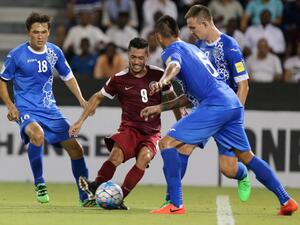 Qatar's Rodrigo Tabata (C) dribbles the ball between Uzbekistan's Anzur Ismailov (R) and Otabek Shukurov (L) during the World Cup 2018 Asia qualification football match between Uzbekistan and Qatar at the Jassim Bin Hamad stadium in Doha on September 6, 2016.
KARIM JAAFAR / AFP