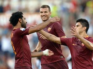 Roma's Argentinian midfielder Diego Perotti (R) celebrates with his teammates Egyptian midfielder Mohamed Salah (L) and Macedonian forward Edin Dzeko (rear C) after scoring during the Italian Serie A football match between Roma and Udinese at the Olympic Stadium in Rome on August 20, 2016.
FILIPPO MONTEFORTE / AFP
