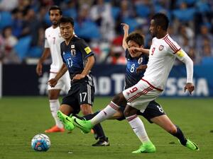 UAE's defender Abdulaziz Hussain Haikal (R) passes the ball as he is marked by Japan's forward Genki Haraguchi (2nd-R) during the FIFA World Cup 2018 qualifier between UAE and Japan at Hazza Bin Zayed Stadium in Al-Ain on March 23, 2017.
NEZAR BALOUT / AFP