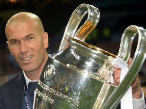 Real Madrid's French coach Zinedine Zidane poses with the trophy after Real Madrid won the UEFA Champions League final football match between Real Madrid and Atletico Madrid at San Siro Stadium in Milan, on May 28, 2016.
Filippo MONTEFORTE / AFP