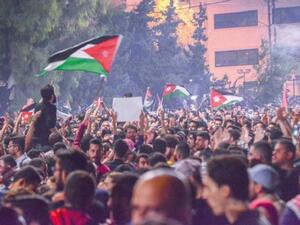 Protesters gather near the Fourth Circle in Amman calling for withdrawal of new income tax draft law from the Parliament on Tuesday. (Jordan Times)