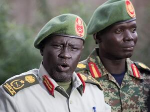 Former Sudan People's Liberation Army (SPLA) chief of general training and former in-opposition general Dau Athorjang (L) speaks during a press conference, pledging his allegiance to the SPLA on July 10, 2016 in Juba. (AFP/Charles Atiki Lomodong)