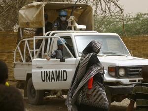 This file photo taken on April 12, 2016 shows members of the UN-African Union mission in Darfur (UNAMID) exiting their vehicle at the Zamzam camp for internally displaced persons in Northern Darfur. (AFP/Ashraf Shazly)