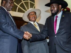 South Sudan's President Salva Kiir, right, shakes the hand of rebel leader Riek Machar in July. (AFP/File)