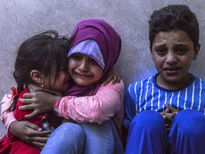 Children cry after leaving their home following a nearby rocket-strike in Kilis. (AFP/file)