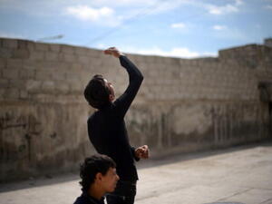 A Syrian young man looks up as a government forces fighter jet flies overhead in the northern Syrian city of Aleppo on April 15, 2013. ( DIMITAR DILKOFF/AFP/Getty Images) A Syrian young man looks up as a government forces fighter jet flies overhead in the northern Syrian city of Aleppo on April 15, 2013. ( DIMITAR DILKOFF/AFP/Getty Images)