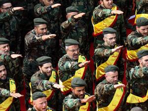 Hezbollah soldiers attend a funeral for a fallen fellow fighter in Syria (AFP/FILE)
