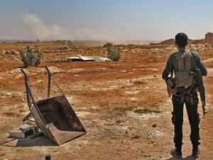 A Syrian rebel looks out to Idlib (AFP/FILE)