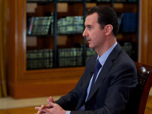 A handout picture released by the official Syrian Arab News Agency (SANA) on October 21, 2013, shows Syrian President Bashar al-Assad giving an interview. (Image credit: AFP)