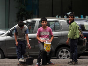 Young Syrian refugees carrying shoe shine kits as they search for customers in a street in Beirutt. Seven million people are in urgent need of humanitarian aid due to the conflict in Syria, a UN top official said. (Image credit: AFP)