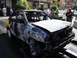 A handout picture released by the official Syrian Arab News Agency (SANA) on October 12, 2013 shows a burnt car after SANA said, two mortar rounds slammed into a  neighbourhood of the Syrian capital Damascus. (Image credit: AFP)