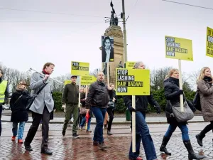 Demonstrators from Amnesty International, a human rights watchdog, protest flogging of jailed Saudi blogger Raif Badawi in front of the Saudi embassy in the Hague.  (AFP/File)