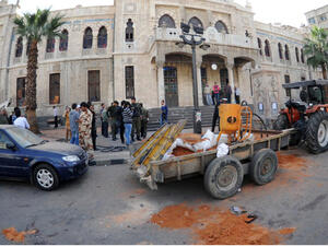 A handout picture released by the official Syrian Arab News Agency (SANA) shows people gathering outside the entrance to the Hijaz railroad company in Hijaz square. (Image credit: AFP)