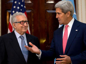 U.N-Arab League envoy for Syria Lakhdar Brahimi (L) listens as U.S. Secretary of State John Kerry speaks. (Image credit: AFP)