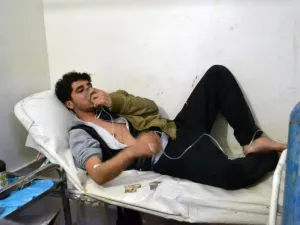 A man in Sarmin, a village outside Idlib, breathes through an oxygen mask after an alleged government gas attack in the area in March 2015.  (AFP/Mohamad Zeen)