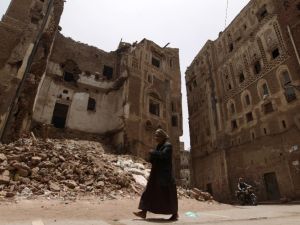 A man walks past a destroyed home in Old Sanaa, a UNESCO World Heritage site boasting mosques and homes dating from before the 11th century.  (AFP/Mohammed Huwais)
