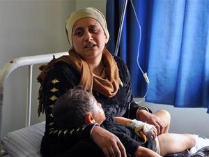 A Syrian Kurdish woman and child await treatment at a hospital in Syria's majority-Kurdish northeastern city of Qamishli following a bomb attack, March 21 2015.  (AFP/File)