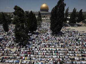 Worshippers at the Al Aqsa compound in Jerusalem participate in this year's first Friday prayers of the Muslim holy month of Ramadan.  Ramadan marks a brief period of eased travel restrictions for many Palestinians.  (AFP/Ahmad Gharabli)
