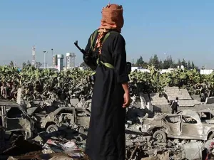 A Yemeni man observes the damage following a Saudi-led coalition airstrike near Sanaa's airport.  (AFP/File)