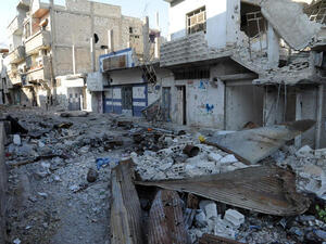 A picture taken on November 13, 2013 shows debris and damaged buildings in the town of Hujeira south of the Syrian capital Damascus. (Image credit: AFP)