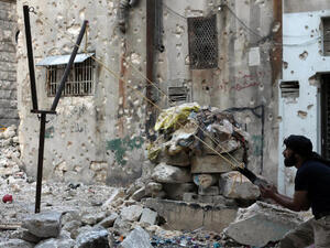 A Syrian opposition fighter aims fire with a catapult towards regime forces in the northern embattled Syrian city of Aleppo. (Image credit: AFP)