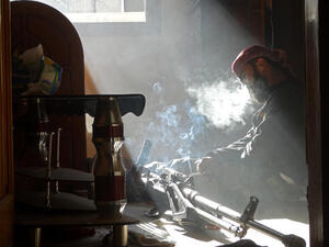 n opposition fighter smokes a cigarette as he takes a break following the injury of his friend. (Image credit: AFP)