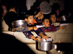 Syrian children beg for food at border crossing area in Syria. [guardian]