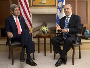 Israeli Prime Minister Benjamin Netanyahu speaks near US Secretary of State John Kerry during a meeting on November 6, 2013 in Jerusalem.