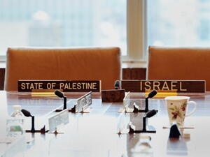 Signs at the seats where Israeli Foreign Minister Tzipi Livni and Palestinian representative Saeb Erekat were to sit in a meeting with the Middle East Quartet during the 68th Session of the United Nations General Assembly September 27, 2013 at UN headquarters in New York. [Stan Honda/Getty Images]