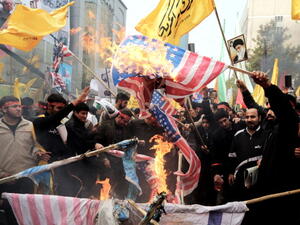 Iranians burn US flags outside the former US embassy in Tehran on November 4, 2013, during a demonstration to mark the 34th anniversary of the 1979 US embassy takeover. [Getty Images]