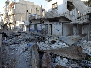 A picture taken on November 13, 2013, shows debris and damaged buildings in the town of Hujeira south of the Syrian capital Damascus. [AFP]