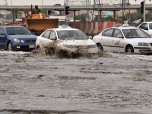 Cars drive through a flooded street in northern Riyadh, on November 17, 2013, after heavy rains fell overnight in the Saudi capital, caused floods and traffic jams. [FAYEZ NURELDINE/AFP/Getty Images]
