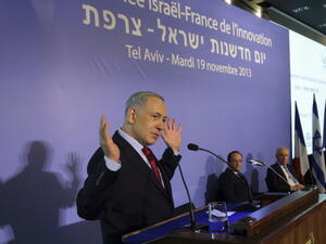 Israeli Prime Minister Benjamin Netanyahu delivers a speech attended by French President Francois Hollande and Israel's President Shimon Peres in Tel Aviv on November 19, 2013. [Getty Images]