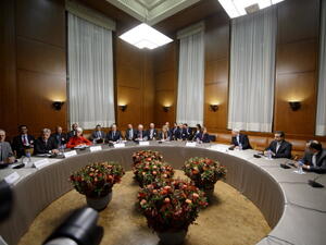 Iranian Foreign Minister Mohammad Javad Zarif  and EU foreign policy chief Catherine Ashton meet with other officials at the start of closed-door nuclear talks in Geneva on November 20, 2013.
