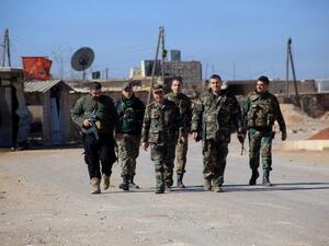 Syrian government forces walk in the village of Tal Jabin, north of Aleppo, as they advanced to break a three-year rebel siege and take control of parts of the supply route on February 3, 2016. (AFP/George Ourfalian)