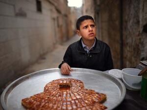 Similar to Omar, this Syrian boy is selling sweets on the streets of Aleppo. (AFP/File)
