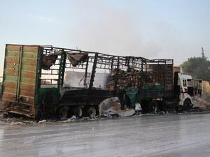 A damaged truck carrying aid is seen on the side of the road in the town of Orum al-Kubra on the western outskirts of the northern Syrian city of Aleppo on September 20, 2016, the morning after a convoy delivering aid was hit by a deadly air strike. (AFP/Omar Haj Kadour)