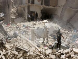 Syrian rescuers search the rubble of a destroyed building following a reported Syrian government forces attack at the Tariq al-Bab neighborhood in the rebel-held area of Aleppo on June 20, 2016. (AFP/Thaer Mohammed)