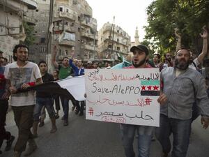 Syrians shout slogans during an anti-regime protest in the rebel-held Bustan al-Qasr district in eastern Aleppo on May 5, 2016. (AFP/Karam al-Masri)