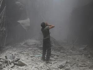 A Syrian man reacts following a reported air strike by Syrian government forces in the rebel-held neighborhood of Bustan al-Qasr on June 5, 2016. (AFP/Baraa al-Halabi)