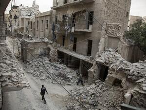 A Syrian man walks past destroyed buildings on May 2, 2016, in Aleppo's Bab al-Hadid neighbourhood which was targeted recently by regime air strikes. (AFP/Karam al-Masri)