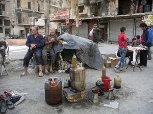 Syrian men sell fuel produced from plastic in the rebel-held side of the northern embattled city of Aleppo on October 27, 2016. (AFP/Karam al-Masri)