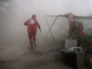 A member of the Syrian Arab Red Crescent searches for victims following a reported government airstrike on the rebel-held town of Douma, near Damascus, on November 10, 2016. (AFP/Abd Doumany)