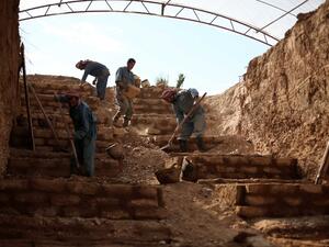 This file photo taken on November 9, 2015 shows workers constructing a layered cemetery in the rebel-held town of Douma, east of the Syrian capital Damascus to make space for the burial of the increasing number of casualties due to airstrikes by the Syrian regime. (AFP/Amer Almohibany)