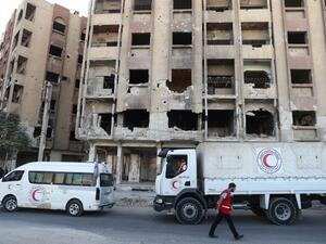 A Syrian Arab Red Crescent lorries are seen in the rebel-held town of Douma, east of the Syrian capital Damascus, on October 19, 2016. (AFP/Abd Doumany)