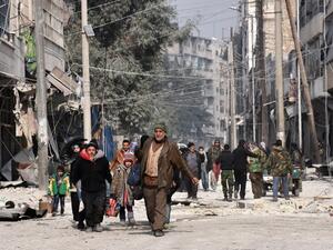 Syrian residents flee violence in Aleppo's eastern al-Salihin neighbourhood on December 12, 2016 after regime troops retook the area from rebel fighters. (AFP/George Ourfalian)