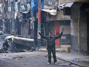A Syrian man gestures in the former rebel-held Salaheddin district in the northern Syrian city of Aleppo on December 23, 2016 after Syrian government forces retook control of the whole embattled city. (AFP/George Ourfalian)