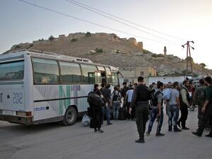 Syrian rebel fighters and their families arrive on the outskirts of Idlib, bordering the Hama province, following their evacuation from Qudssaya and al-Hamah, rebel-held neighbourhoods of the Syrian capital, on October 14, 2016. (AFP/Omar Haj Kadour)