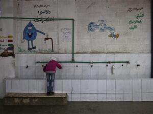 A Syrian girl drinks water at a school near Damascus on October 19, 2016. (AFP/File)